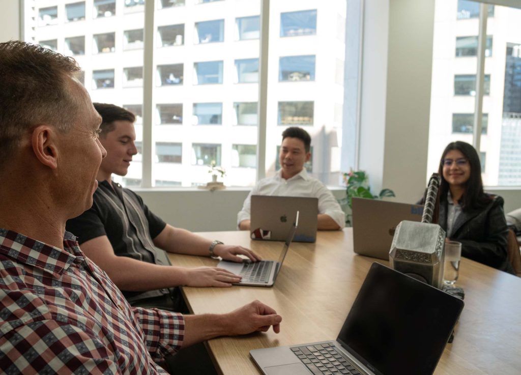 The Bliss team working through a plan around the boardroom table