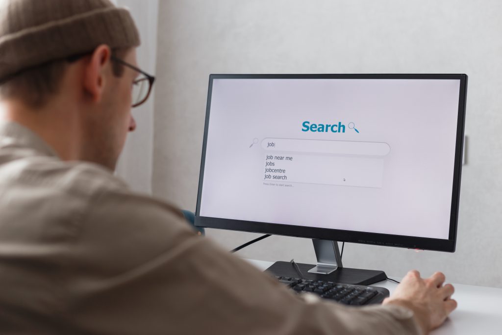Someone typing a question into a search box on a desktop screen