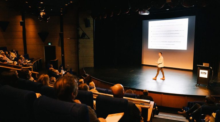 Bliss speaking at a conference